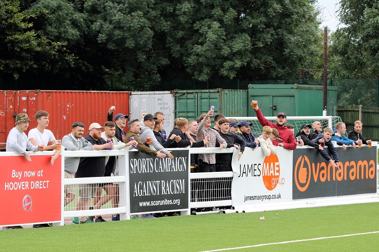 Fans alongside the goal