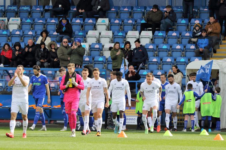 The team comes out in the all white away kit