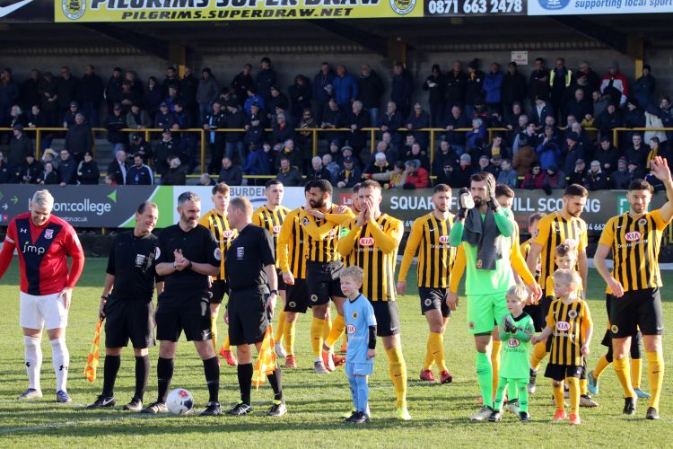 The team lines up with the mascots